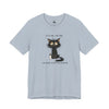 A light blue crewneck t-shirt featuring a cartoon graphic of a black cat with messy hair holding a bottle, with the text 'IT'S FINE. I'M FINE' above and 'I'M JUST A KITTEN FOSTER' below.